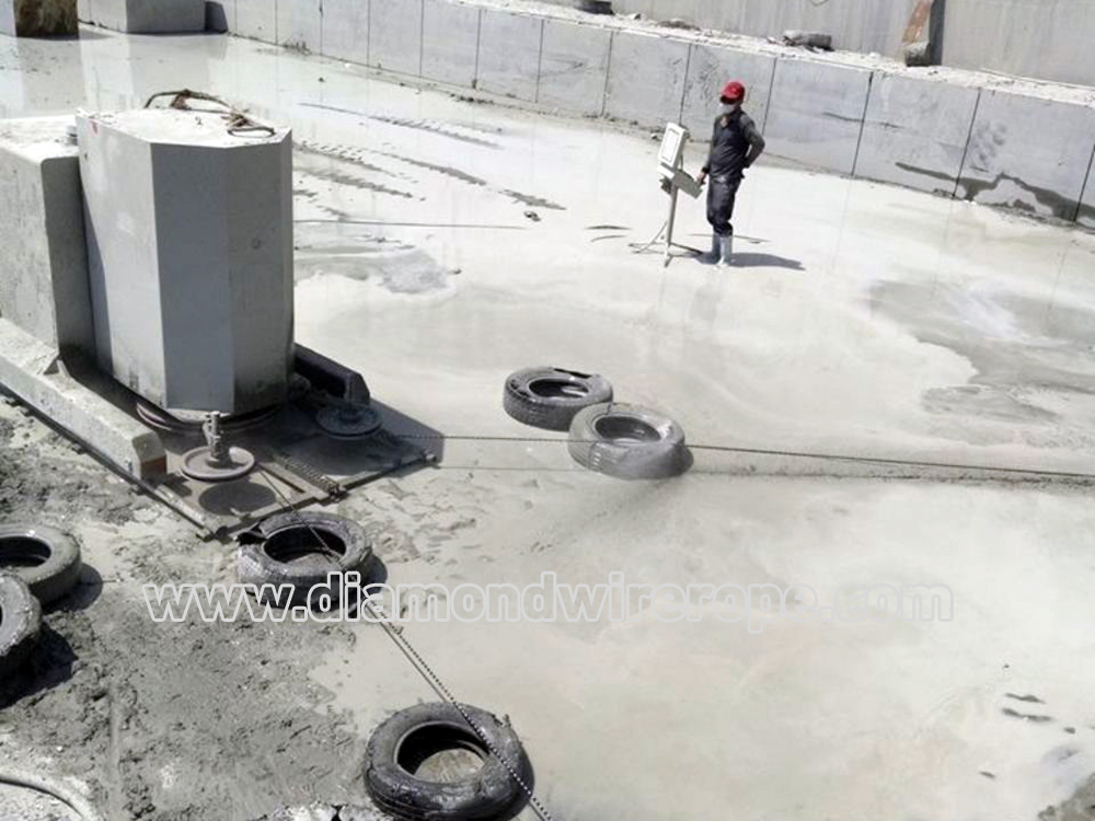 Diamond rope saw is quarrying granite block